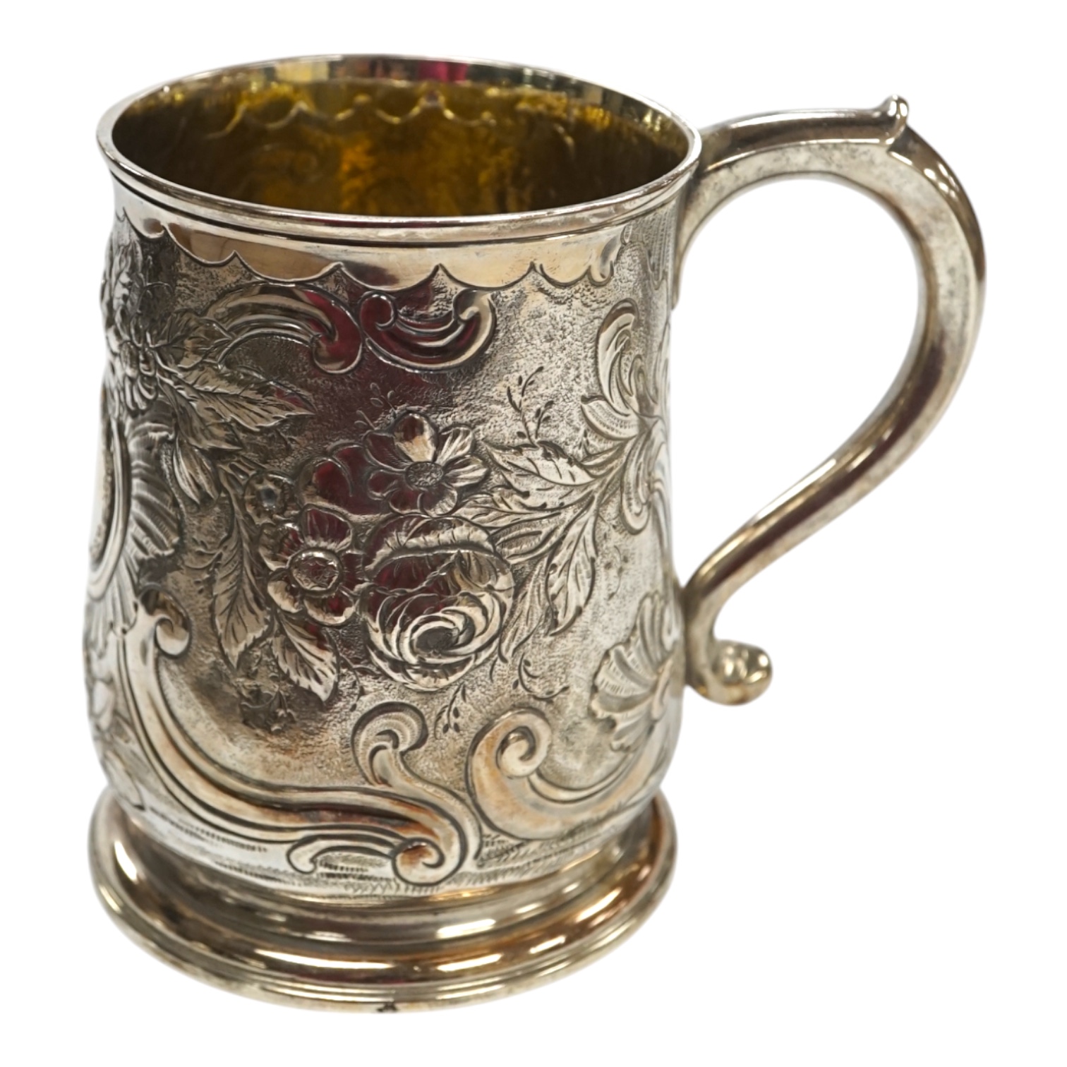 A George II silver mug, with later embossed decoration, Thomas Rush, London, 1733, 11.5cm, 11.9oz. Condition - fair to good